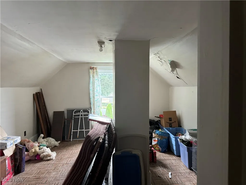 Bedroom featuring vaulted ceiling