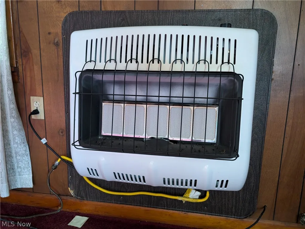 Details featuring wood walls and heating unit