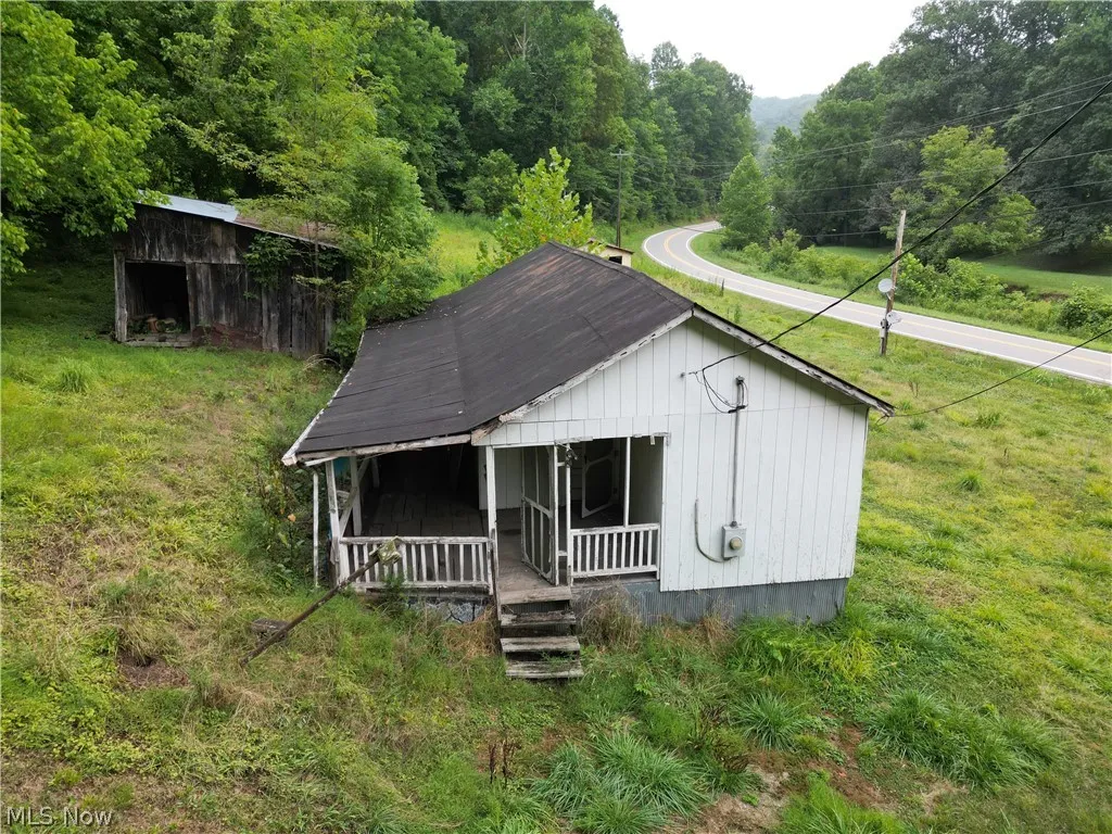 View of front of home featuring a porch and a front lawn