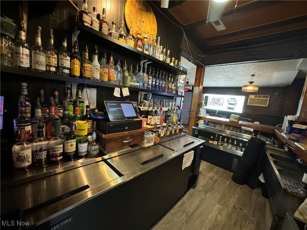 Bar featuring wood-type flooring