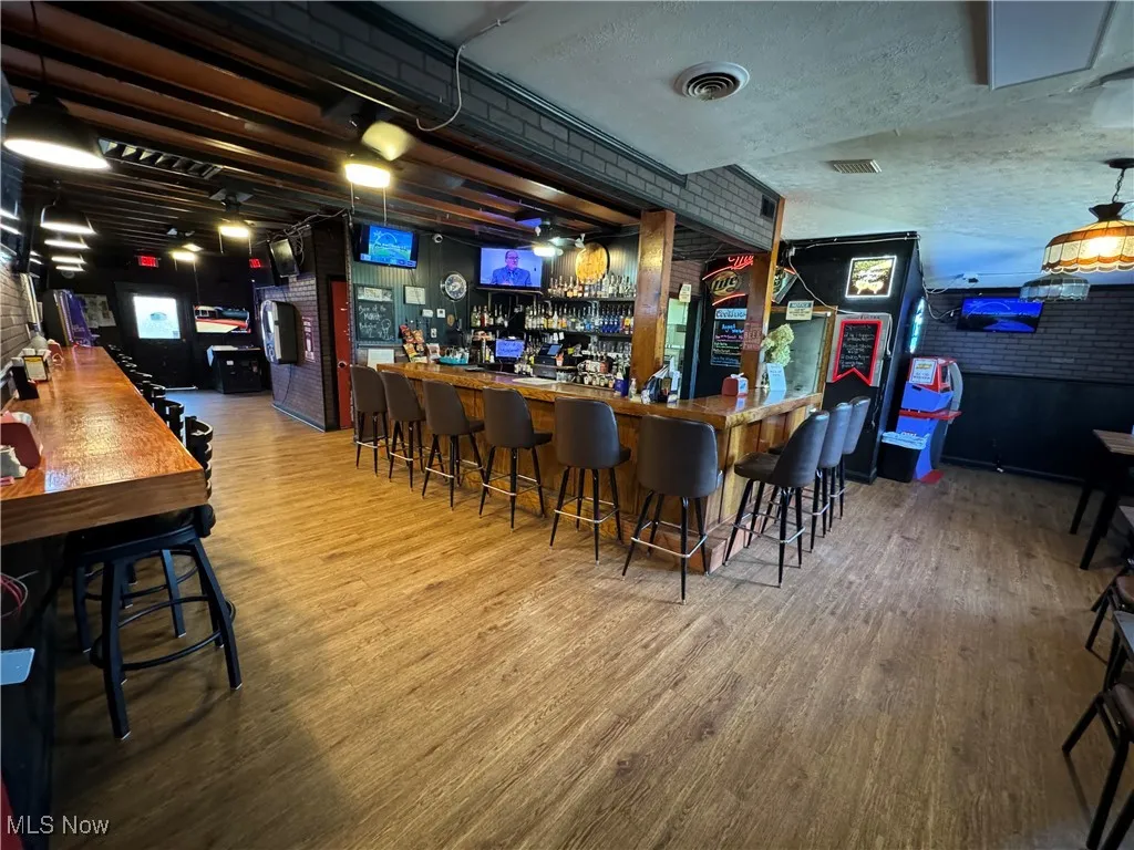 Bar with hardwood / wood-style floors