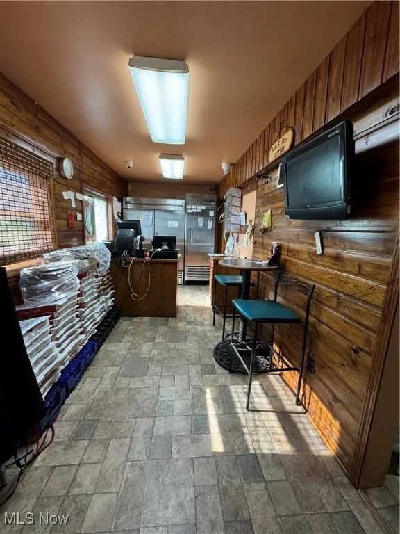 Kitchen featuring tile patterned floors and wooden walls