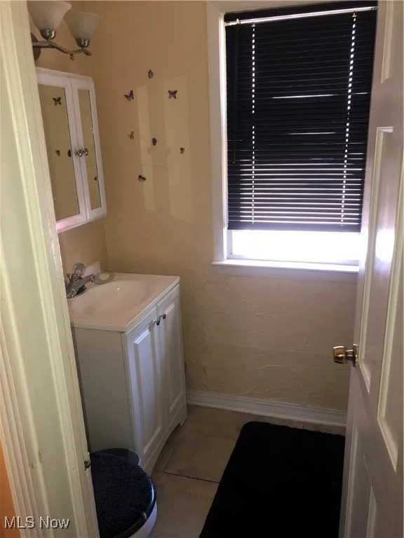 Bathroom with tile patterned flooring, toilet, and vanity
