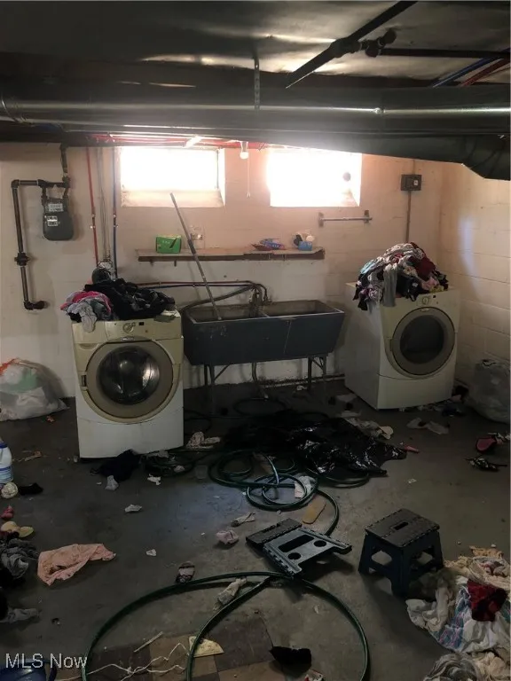 Washroom featuring sink and washer / dryer
