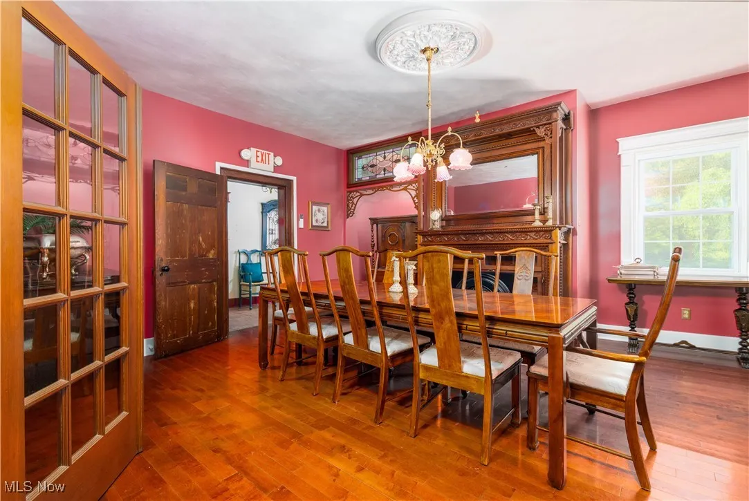 Dining space with wood-type flooring and an inviting chandelier