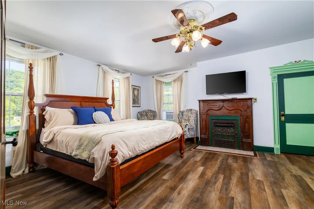 Bedroom featuring dark wood-type flooring and ceiling fan
