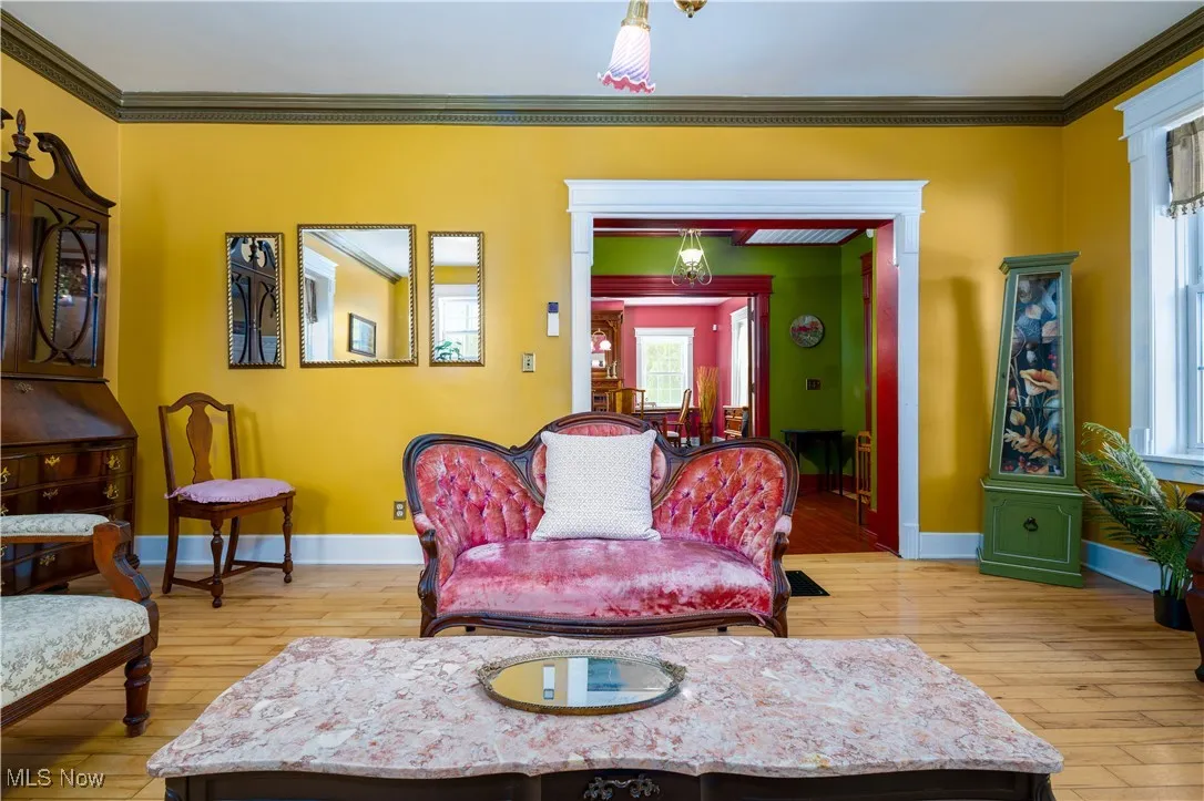 Living room featuring ornamental molding and hardwood / wood-style floors