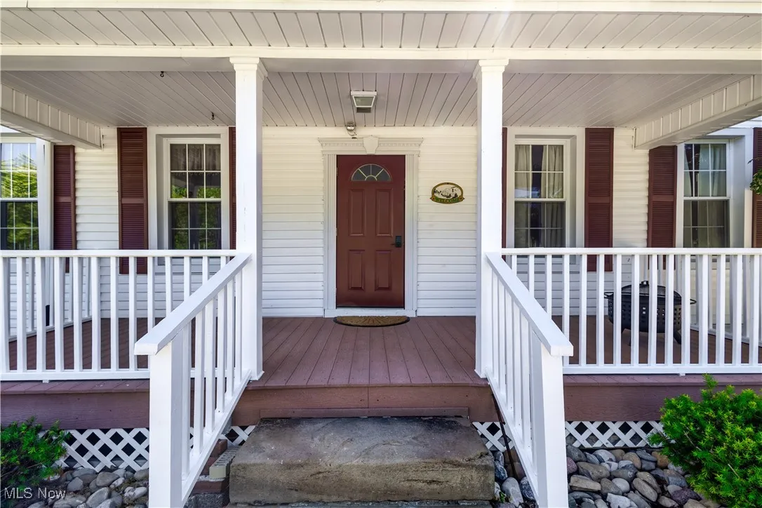 Entrance to property featuring a porch