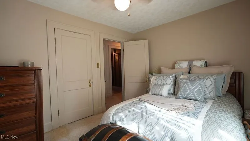 Bedroom featuring ceiling fan and light carpet