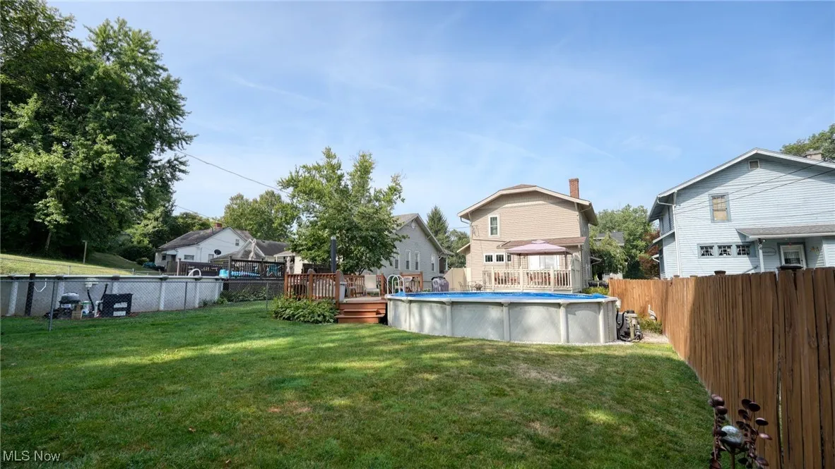View of yard with a swimming pool side deck