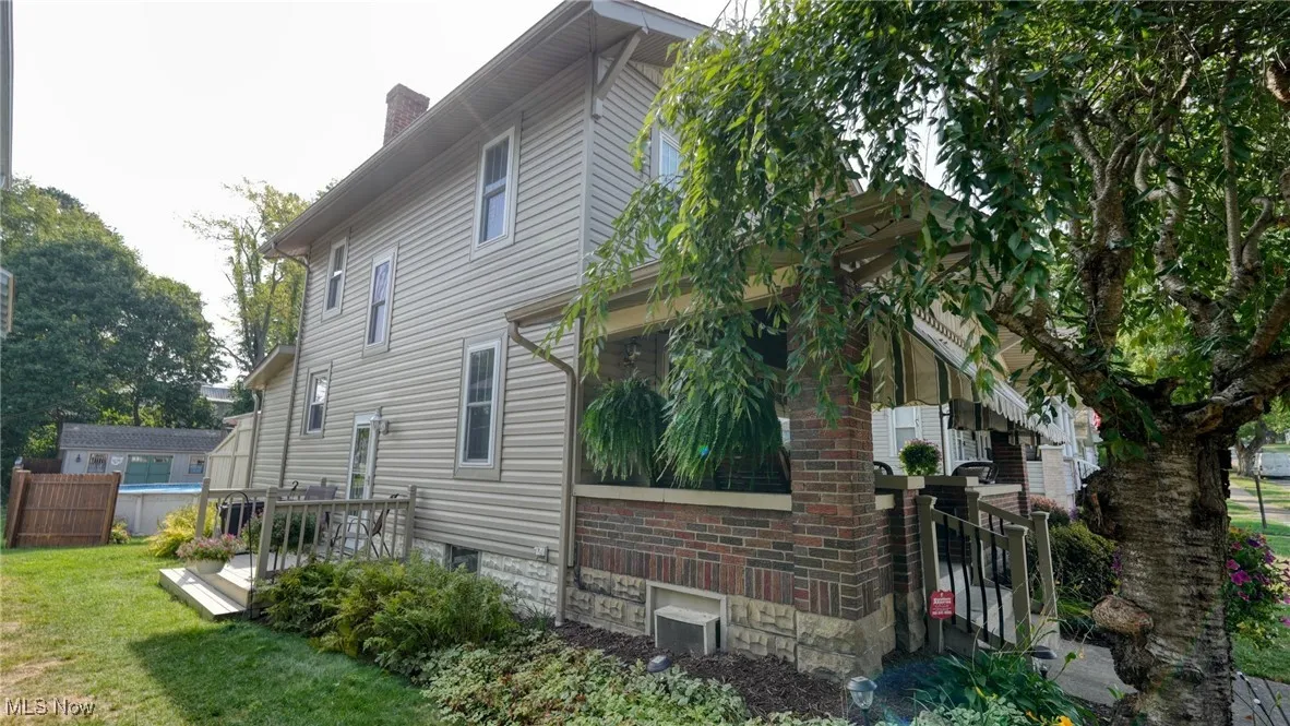 View of property exterior featuring a yard