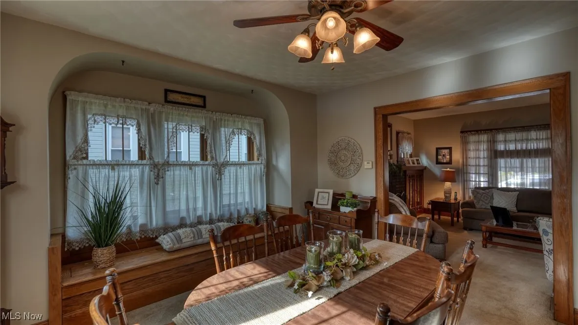 Dining room featuring light colored carpet and ceiling fan