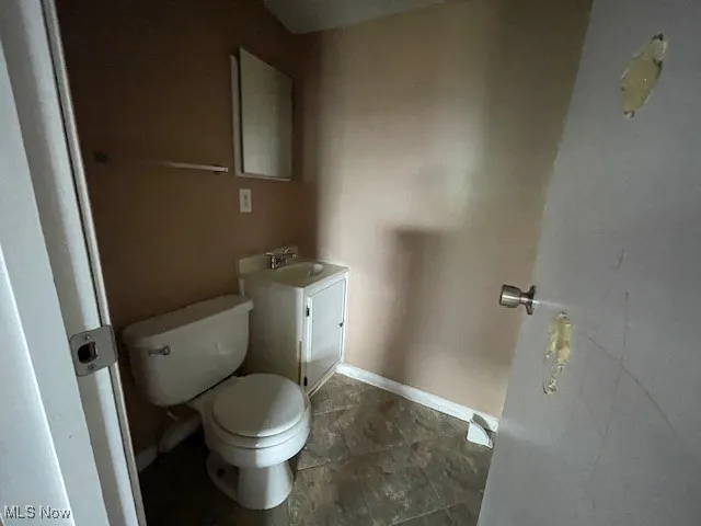 Bathroom featuring tile patterned floors, vanity, and toilet