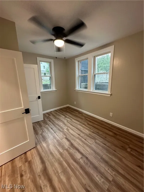 Unfurnished room with ceiling fan and light hardwood / wood-style floors