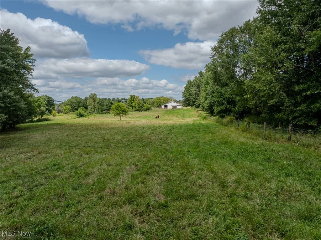 View of yard with a rural view