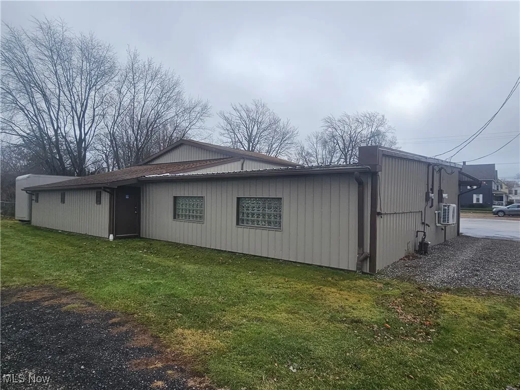 View of side of property featuring a yard