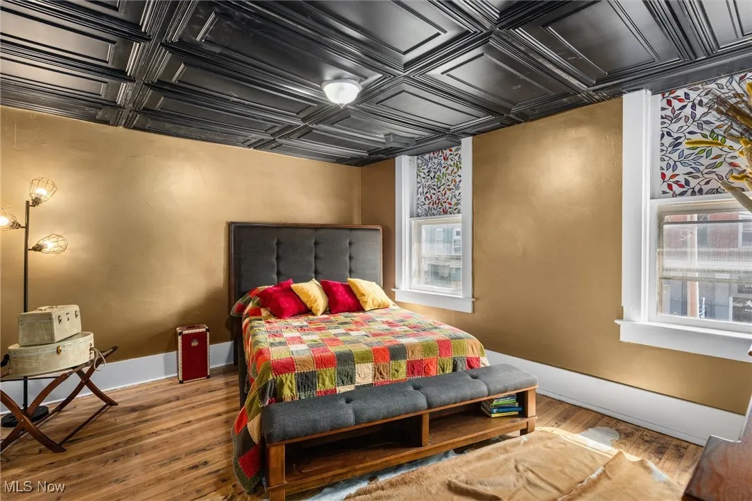 Bedroom featuring hardwood / wood-style flooring and coffered ceiling