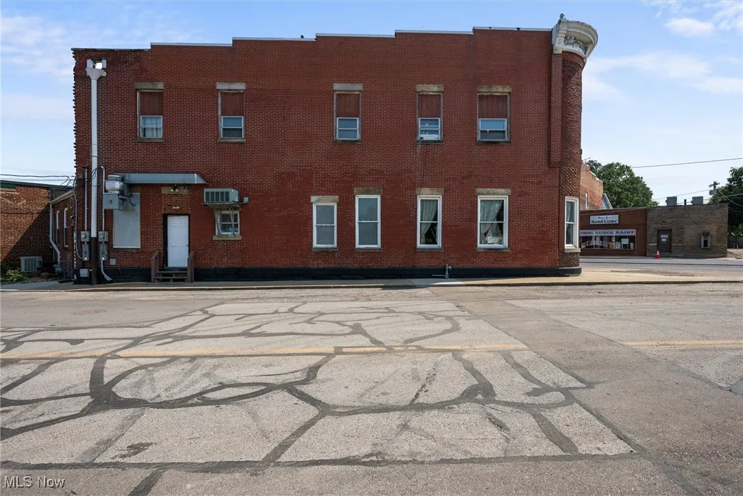 View of building exterior featuring central air condition unit