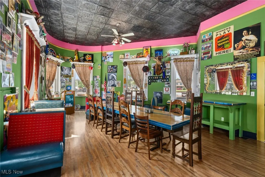 Dining room with ceiling fan and hardwood / wood-style floors