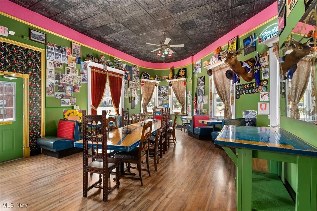 Dining space with a wealth of natural light, ceiling fan, and hardwood / wood-style floors