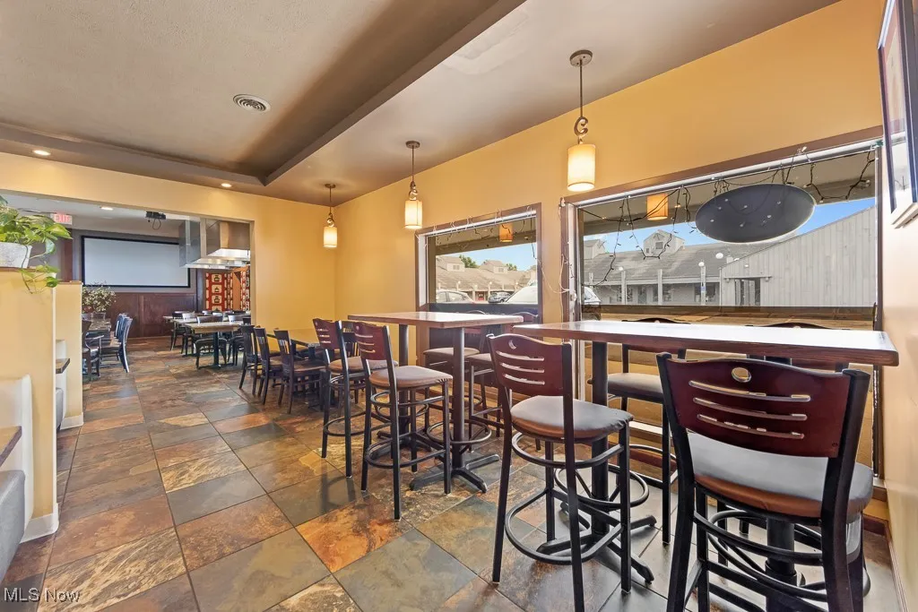 Tiled dining room with a tray ceiling