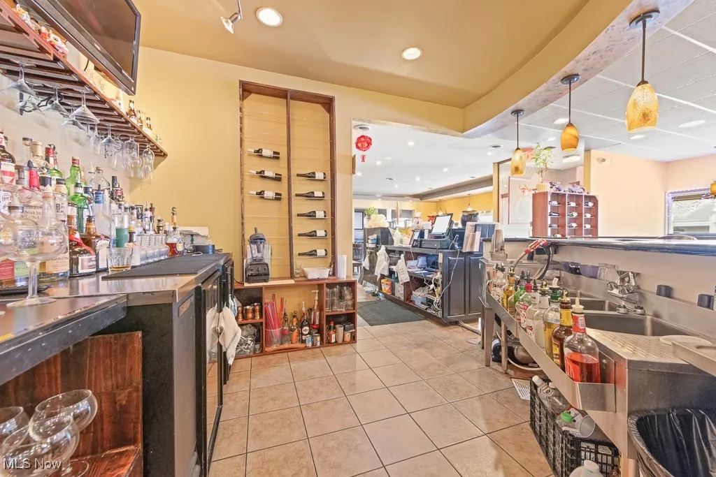Kitchen featuring light tile patterned floors and decorative light fixtures