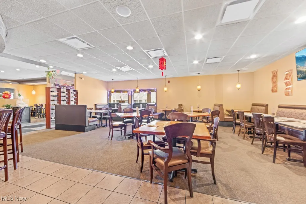 Tiled dining space with a drop ceiling