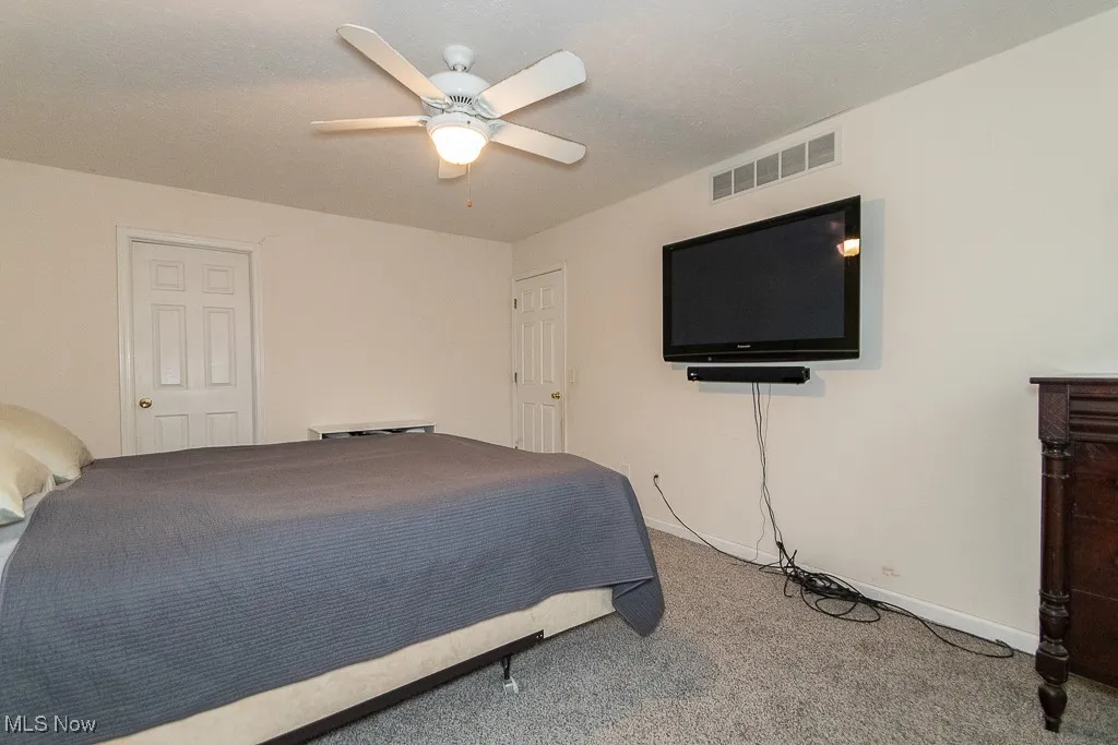 Bedroom with carpet floors and ceiling fan
