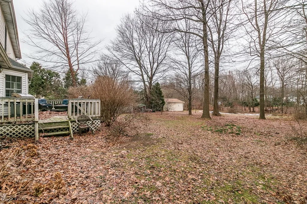 View of yard with a wooden deck