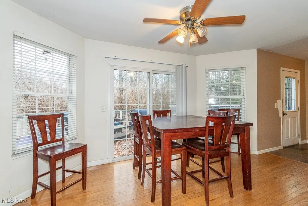 Dining room featuring ceiling fan, plenty of natural light, and light hardwood / wood-style flooring