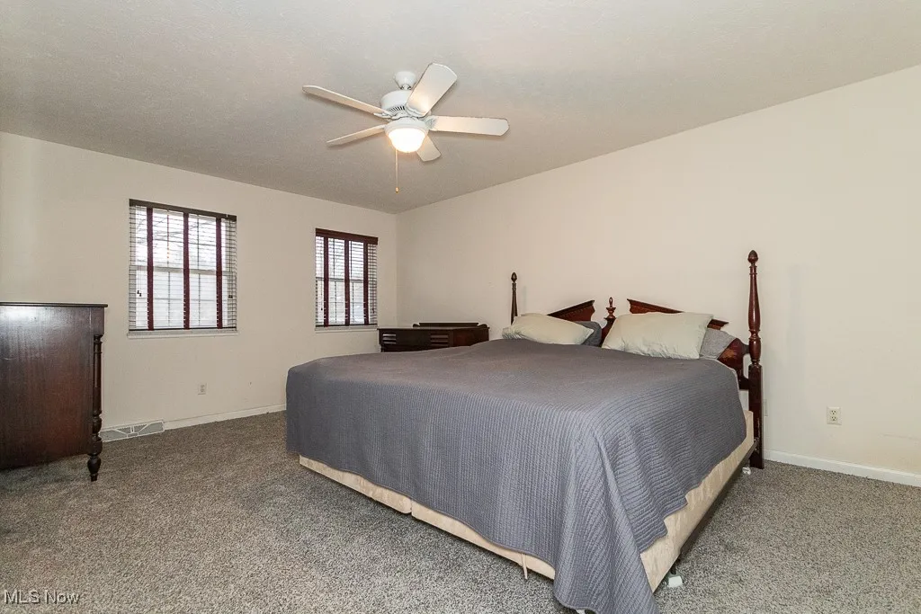 Bedroom with carpet and ceiling fan
