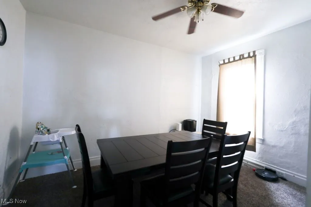 The Dining Room measures 13 x 11 with carpet and a ceiling fan with light fixture.