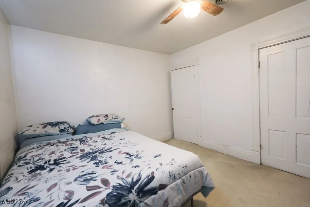 Another view of the Primary Bedroom featuring carpeted flooring and a closet.