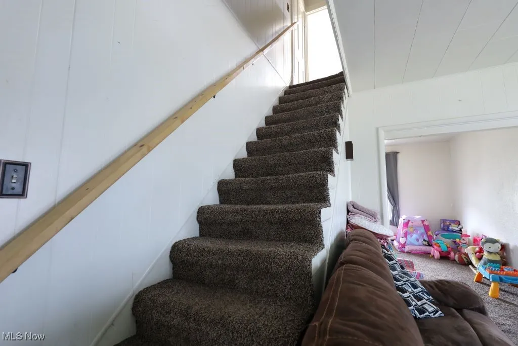 Carpeted stairway to the 2nd floor.