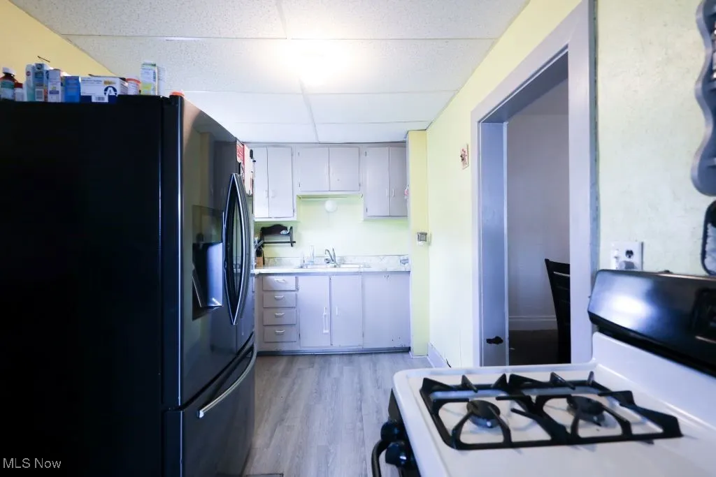 This view of the Kitchen shows the refrigerator and the gas stove.  Just off of the kitchen is the Dining Room.