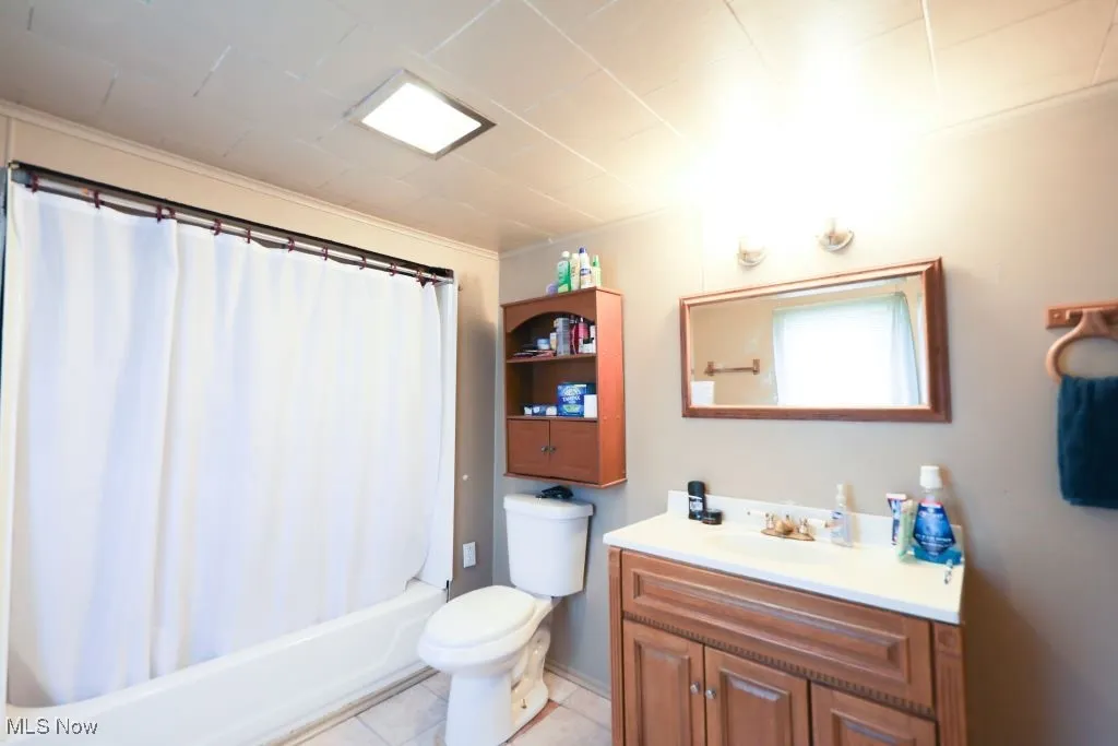 Full bathroom featuring vanity, shower / bath combination and laminate flooring.  This bathroom is huge and measures 14 x 8.  It also features a laundry shoot.