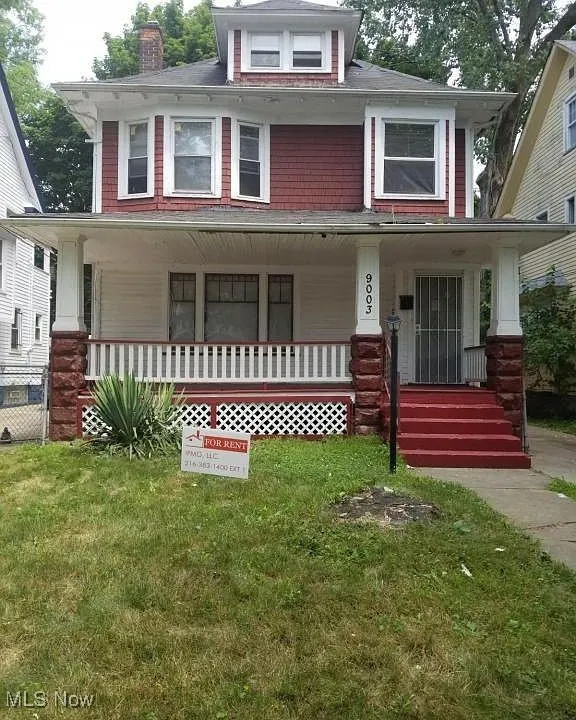 View of front of house with a front lawn and covered porch