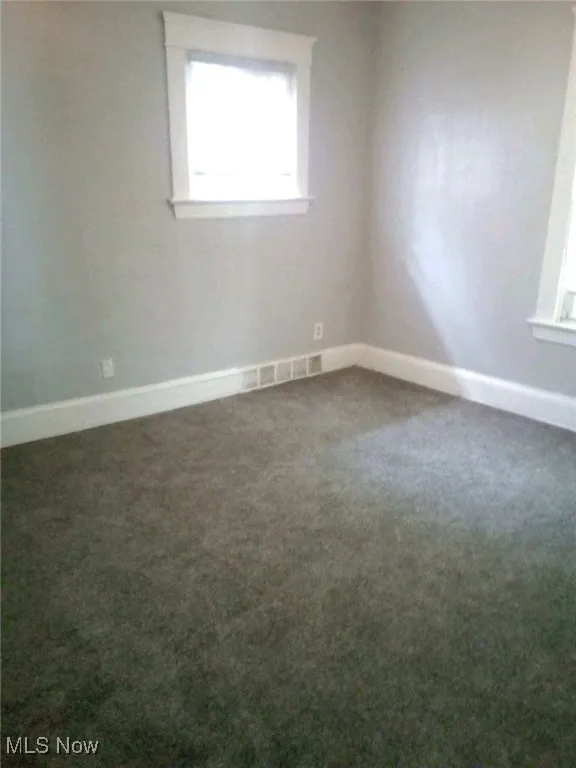 Spare room featuring carpet flooring