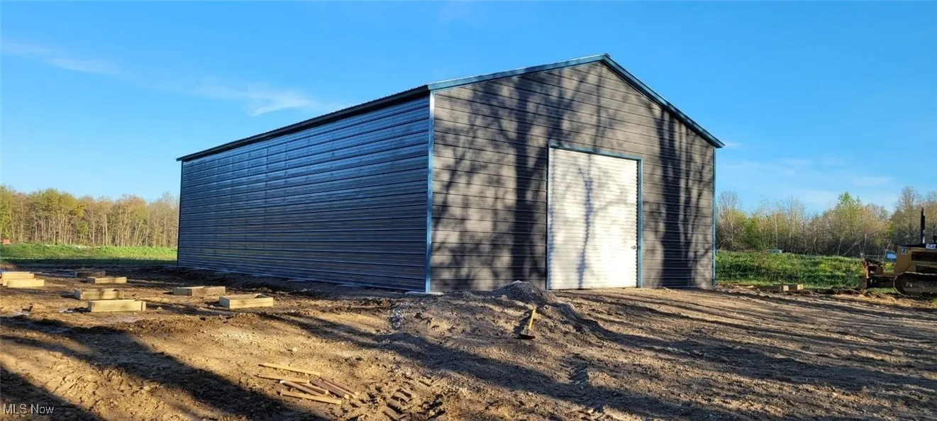 View of outbuilding featuring a garage