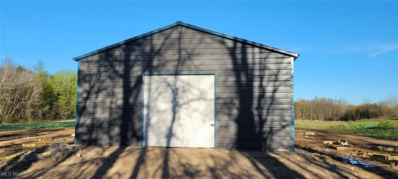 View of outdoor structure featuring a garage