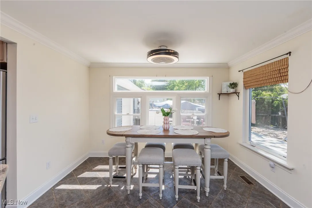 Dining area to kitchen and living room with panoramic water views