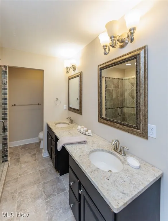 Primary private bathroom with walk in tiled shower and separate tub to soak and unwind