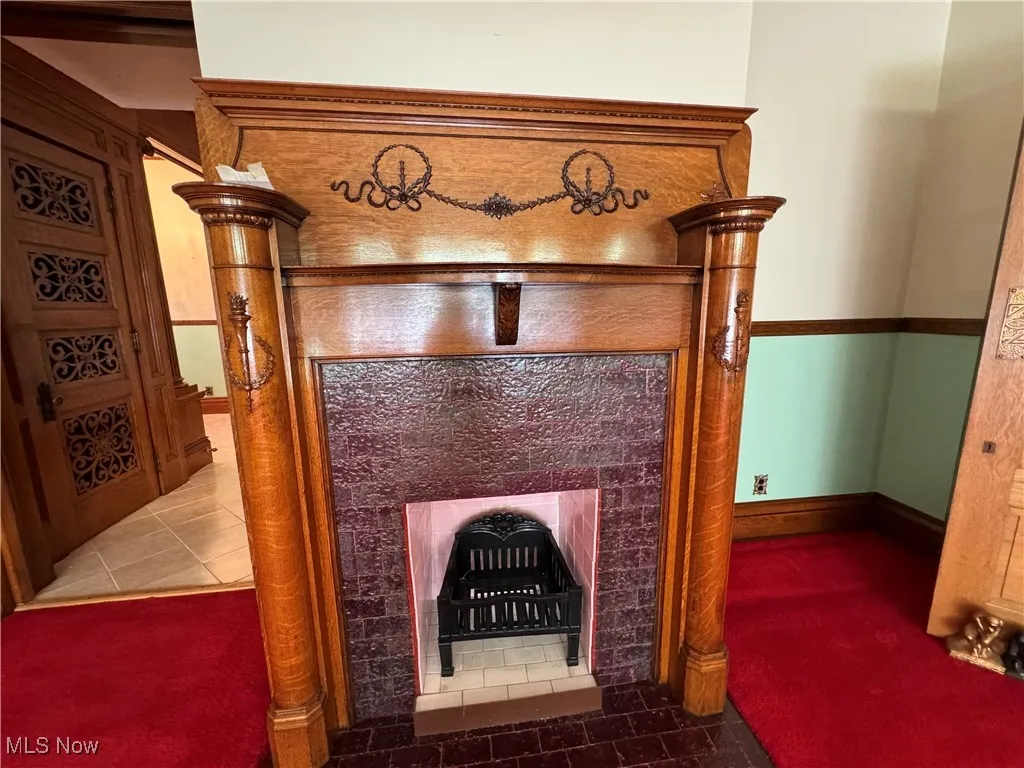 Interior details with a tiled fireplace and tile patterned floors