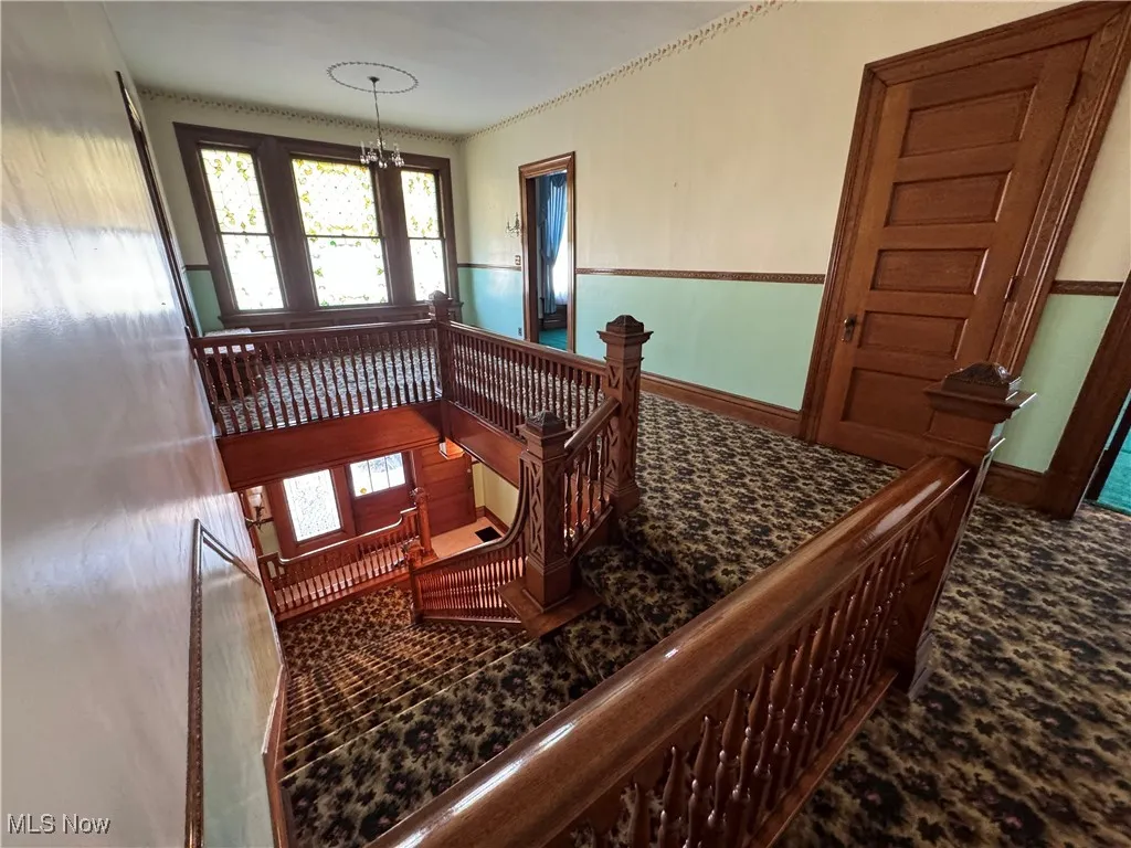 Staircase with an inviting chandelier