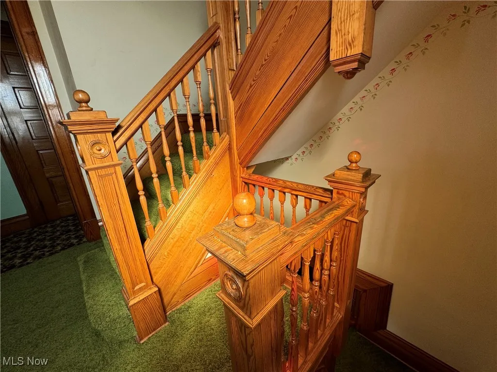 Staircase featuring carpet