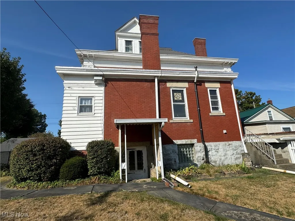 Rear view of house with a yard