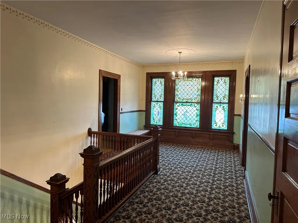 Corridor with an inviting chandelier