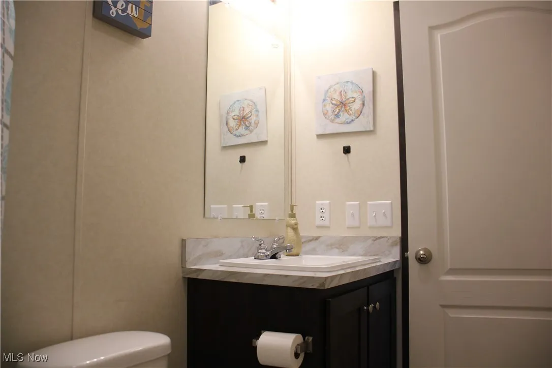 Bathroom featuring vanity and toilet