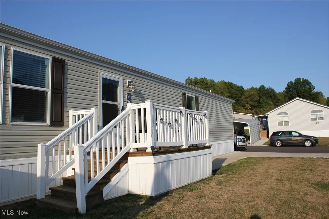 View of side of home with a yard