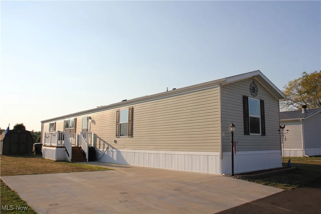 View of front facade with a storage shed